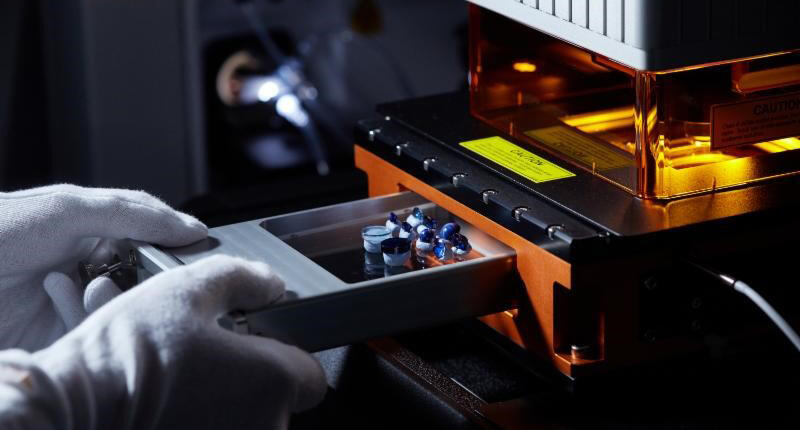 A technician places sapphire for analysis in the GemTOF instrument, which identifies with precision the chemical components in gemstones, allowing SSEF to be able to provide more information about the origin of a variety of colored stones. 20161116_GemTOF.jpg