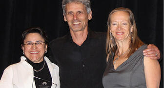 Dr. Camilla Bustamante of Santa Fe Community College (left) presented New Mexico’s Green Business of The Year Award to Reflective Jewelry President Marc Choyt and his wife and co-founder Helen Chantler last week. 20190626_Reflective_Jewelry.jpg