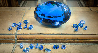 The 9,381-carat blue topaz at center, dubbed “The Ostro Stone,” was discovered in 1960 in Minas Gerais, Brazil, by British gemstone pioneer and explorer Max Ostro. 20160928_Ostro-topaz.jpg