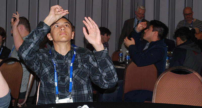 Tucson high school students who are part of the DCA’s Jewelry Career Readiness Initiative look closely at gemstones as AGTA CEO Doug Hucker explains double refraction. 20170208-JCRI-students.jpg