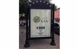 W. Kodak Jewelers advertises the type of gemstone grading reports it uses as a way of standing out, Brad Kodak says. The advertisement seen here is located on a bus stop shelter along Washington Street, the main drag of Hoboken, N.J. 101714_Kodak-article.jpg