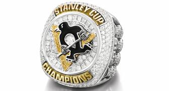 Crafted in 14-karat gold and set with yellow and white diamonds, the Stanley Cup rings given to the Pittsburgh Penguins have each players’ name and number on one shank. On the other are four diamond-set Stanley cups, representing the team’s four NHL championships. 20161014_Penguins-ring-main.jpg