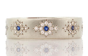 Adel Chefridi of Woodstock, N.Y., won in the Wedding jewelry category of the Niche Awards for his “Shimmer” band with diamond and sapphires. 012714_Niche-Article.jpg