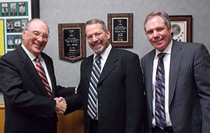 Rogers Jewelry Co. owners Roger Marks and Bart Marks congratulate sales associate Leroy Kisling (center) on winning the ArtCarved in Rome sweepstakes. 032614_AC-Article.jpg