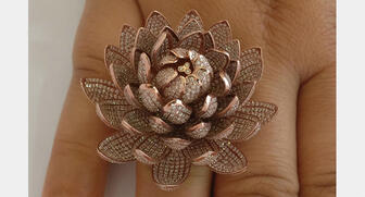 This 18-karat gold ring is set with 6,690 cut diamonds, which Guinness World Records said is the highest number ever set in one ring. 20180703_Record-ring.jpg