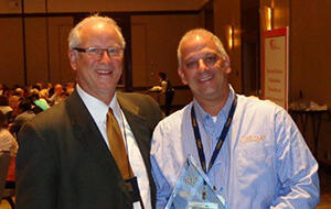 RJO President Terry Dickens, left, stands with Tim Marr of Ostbye, who was one of two members awarded the 2014 RJO Sales Representative of the Year Award at the organization’s annual Vendor of the Year Awards held in Minneapolis. 082814_RJO-Article.jpg